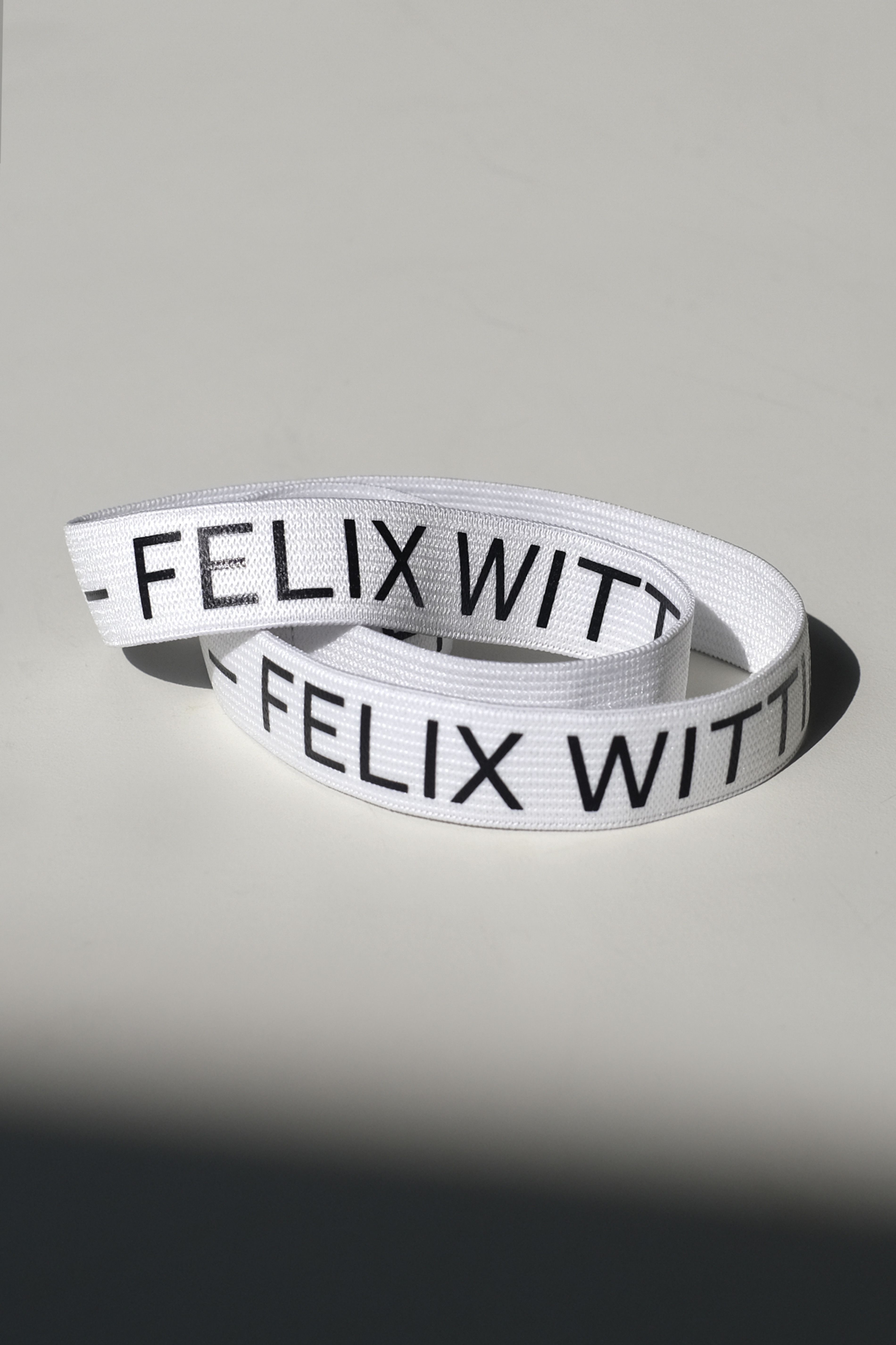 white textile band with black typography