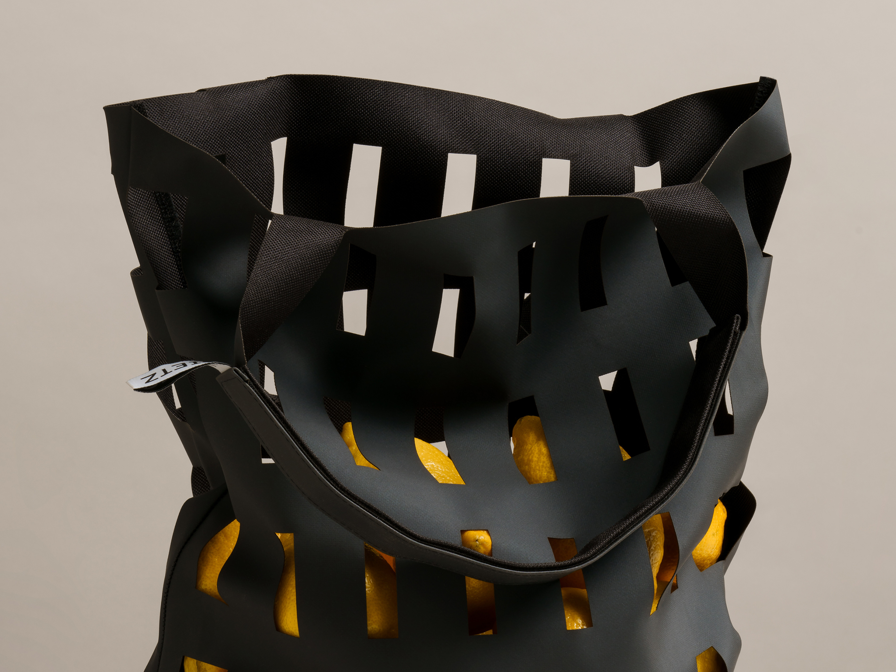 Detail of a black Good Buy! Dietz bag with lemons