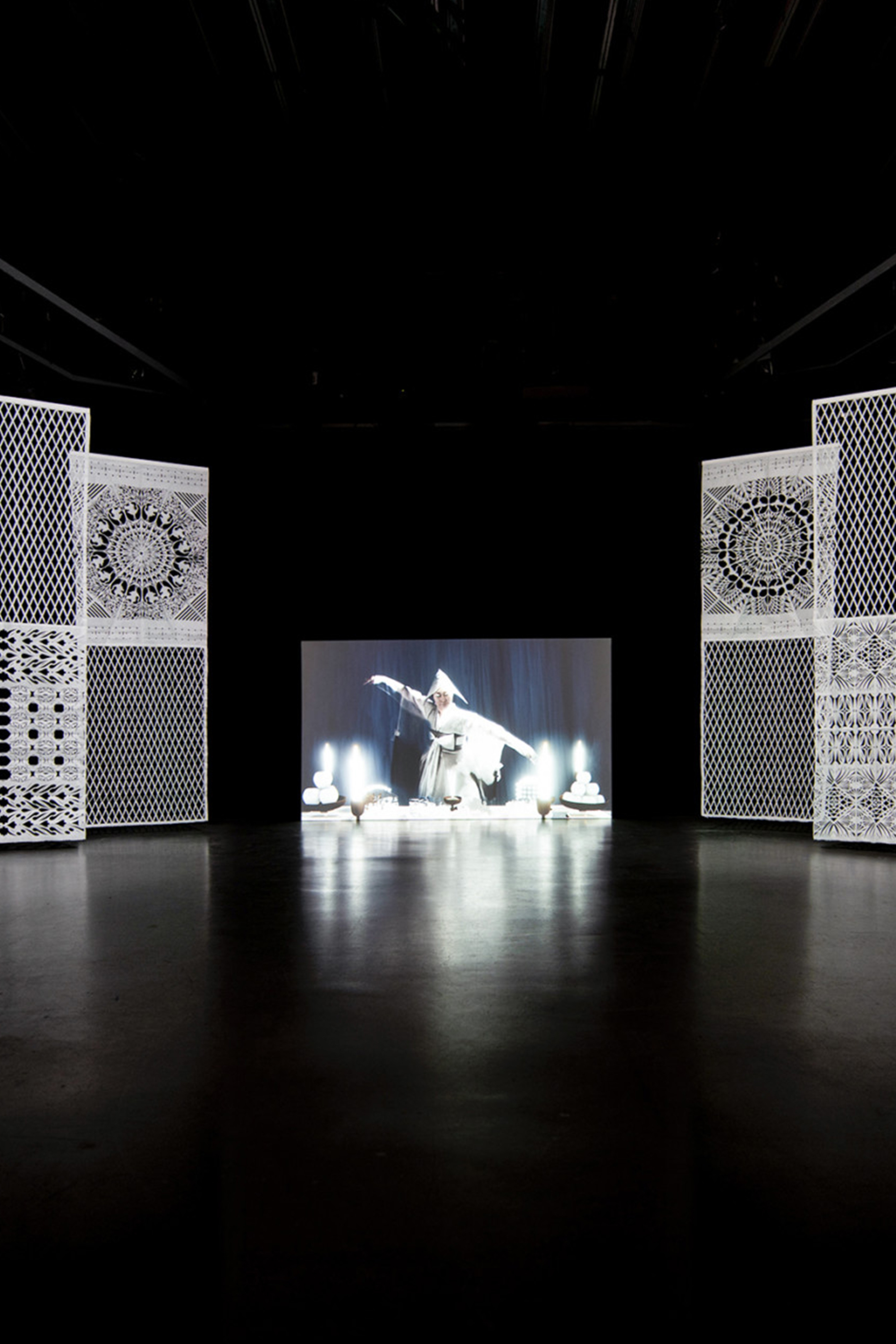 Exhibition of the Hanna Noh's work, showing the film with paper curtains on the sides.